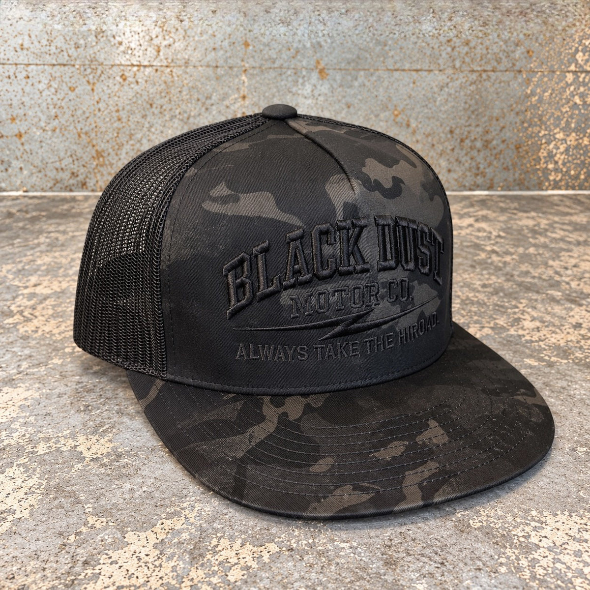 Black camo trucker hat, three-quarter view