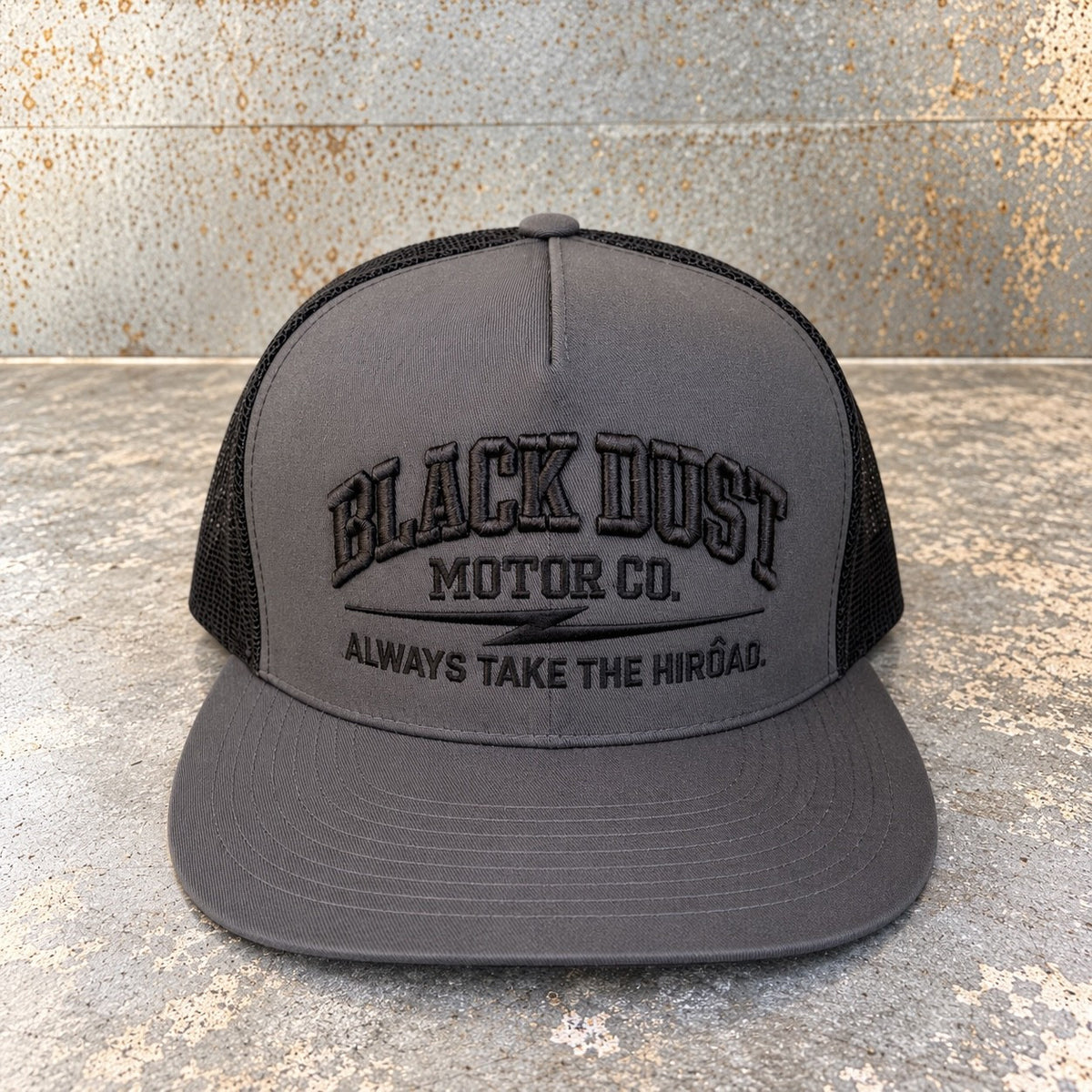 Charcoal trucker hat with black mesh back and black embroidered logo, front