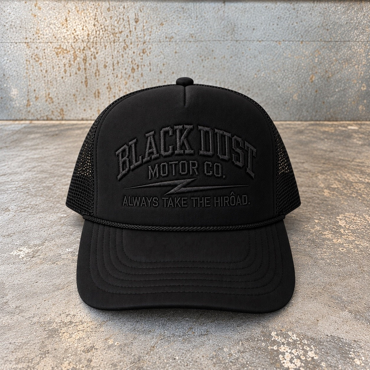 Black foam trucker hat with tone-on-tone embroidered Black Dust Motor Co. logo, front