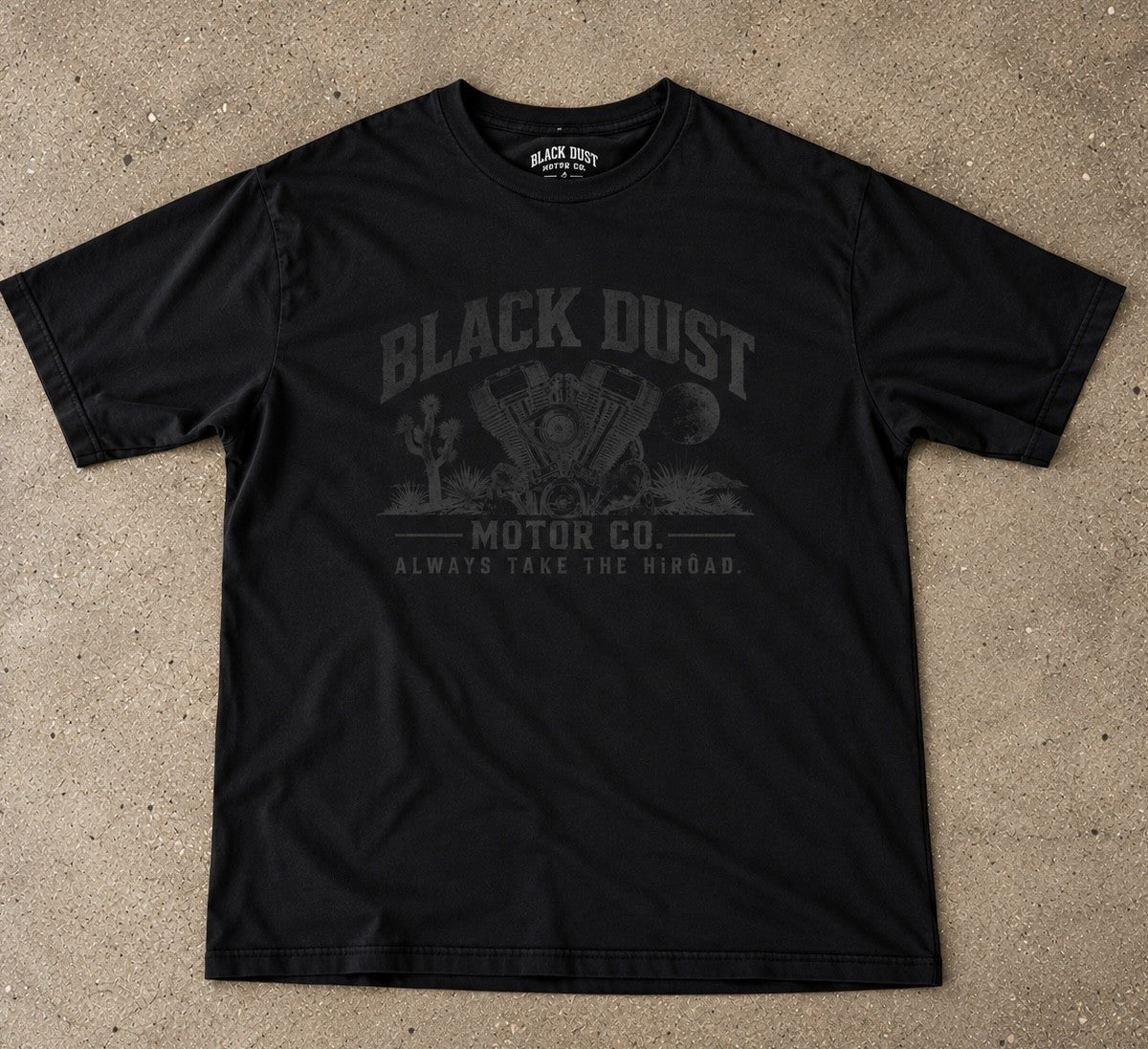 Black tee with a V-twin engine among Joshua trees under the moon, Black Dust Motor Co.